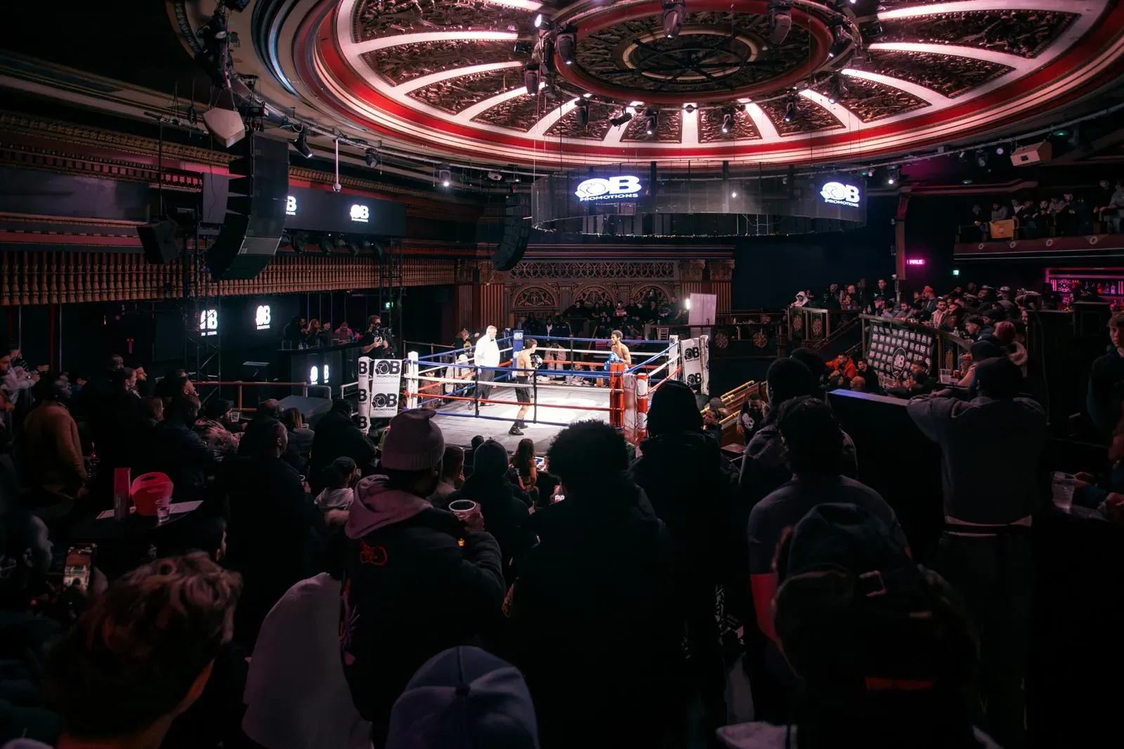 Odera coaching and training boxing clients in the gym